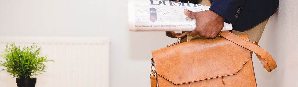 man with newspaper and briefcase